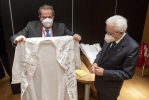 Il Presidente della Repubblica Sergio Mattarella in occasione della visita alla Fondazione Toscana Life Sciences riceve in omaggio un camice con le firme dei ricercatori della Fondazione